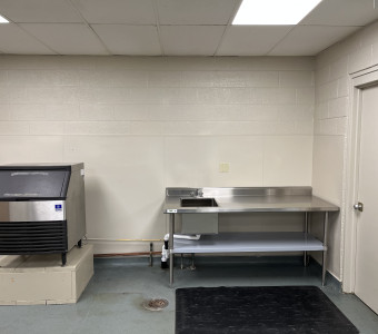 The Incubator Kitchen includes a 30" x 72" stainless steel food processing table with sink and an ice maker.